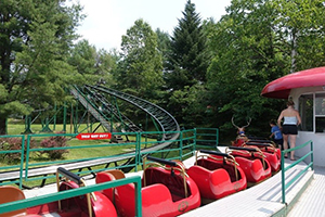 empty red amusement ride sitting next to a platform