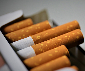 Package of cigarettes with just the white and brown filters peeking out of the top.